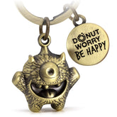 "Cyklops" Schlüsselanhänger Mutmacher - Süßes Glücksmonster mit Gravur "Donut worry, be happy!" - Kummermampfer Glücksbringer - FABACH#farbe_antique bronze
